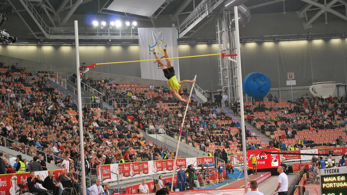 Pole-vault clearance — kinetic-to-elastic energy conversion.