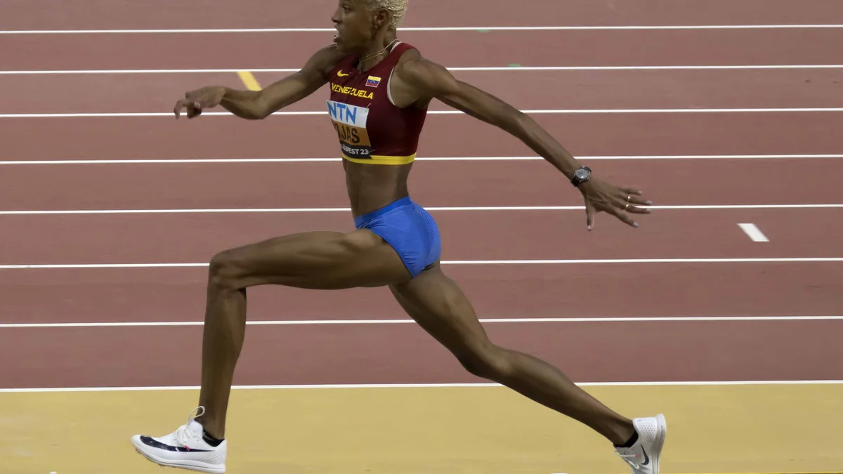 Triple jump — hop-step-jump phase in flight.